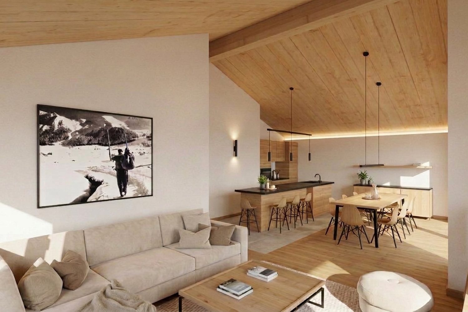 Visuel intérieur : canapé d'angle clair, photographie de montagne au mur, cuisine ouverte au fond.